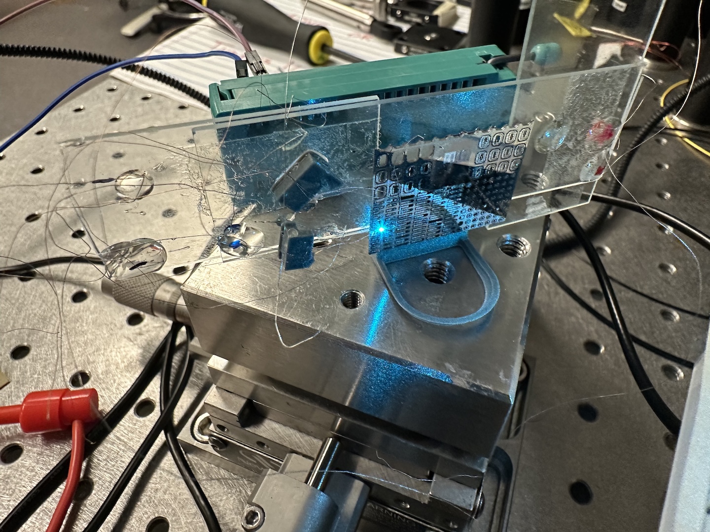 Laser shining on a microdevice on the wafer.